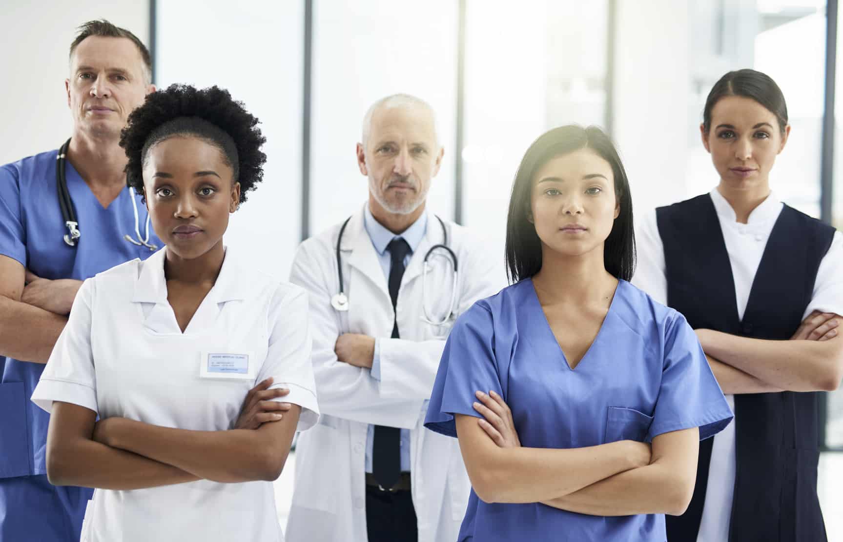 Cropped portrait of a group of medical professionals standing with their arms crossed in a hospital