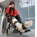 woman with leg cast in wheelchair